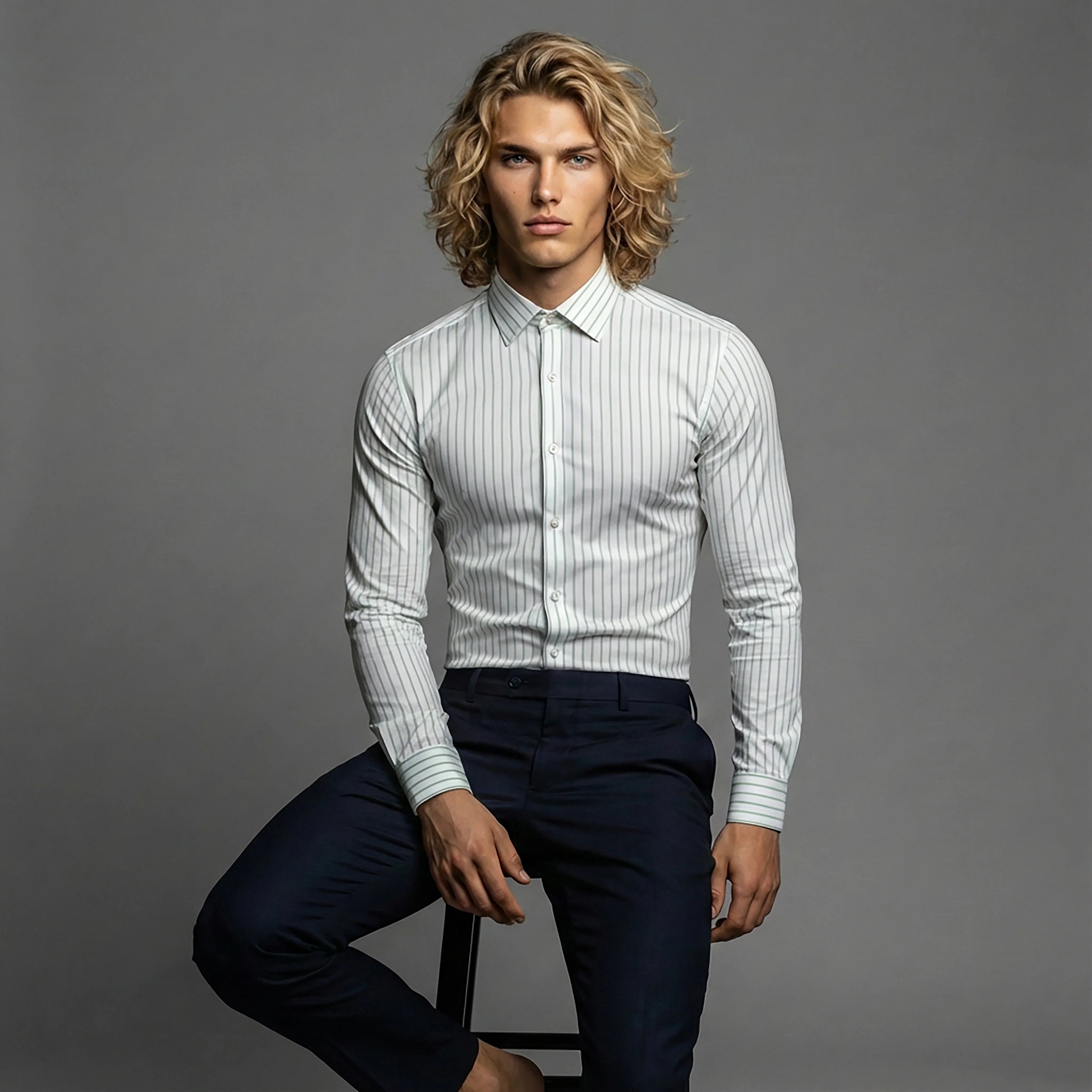 DGMAH slim fit striped dress shirt and navy trousers on model, gray background