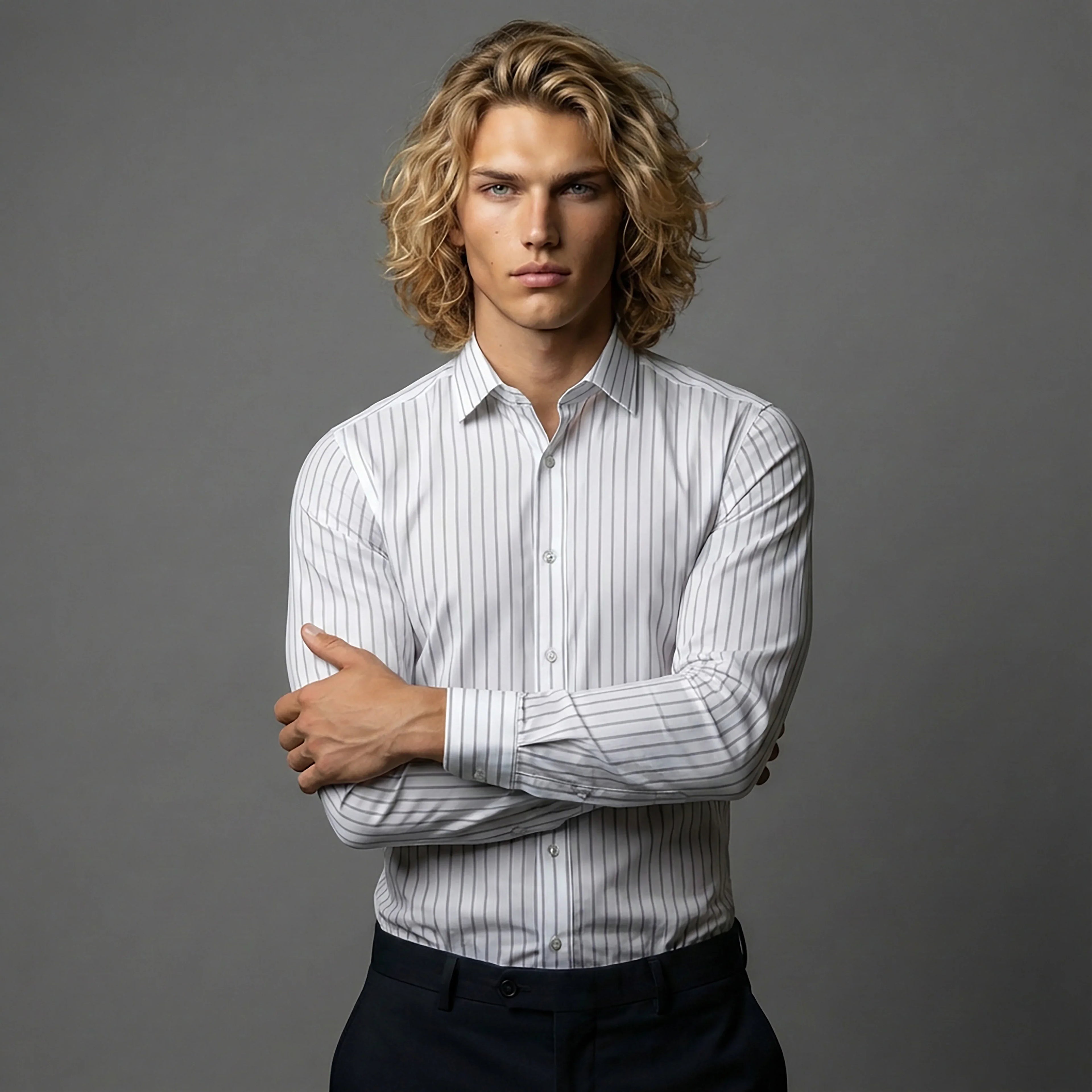 Man in striped white dress shirt posing against gray background for DGMAH fashion