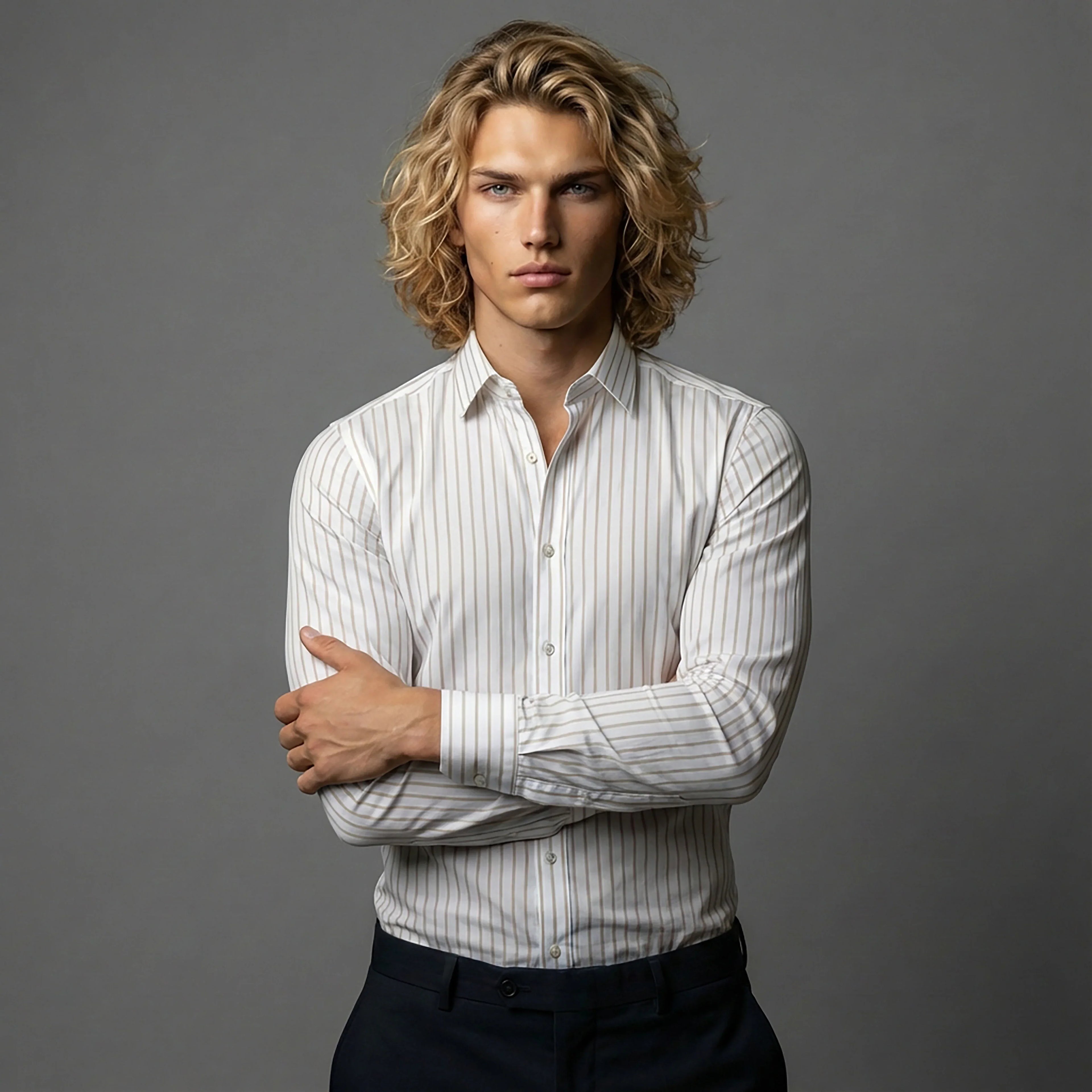 Man in white striped dress shirt with crossed arms, DGMAH fashion studio shoot