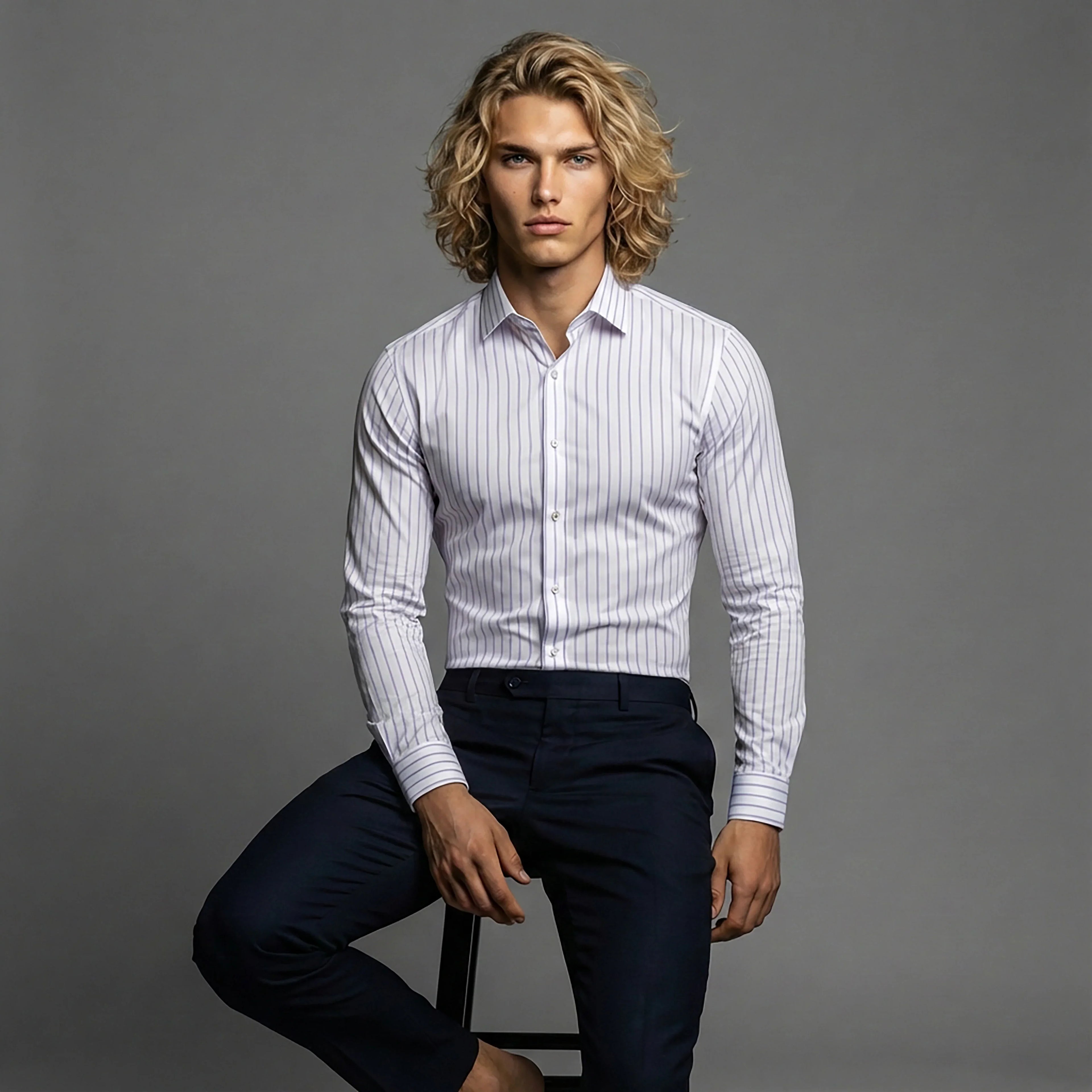 Man in slim fit white striped dress shirt and dark pants, seated, DGMAH fashion